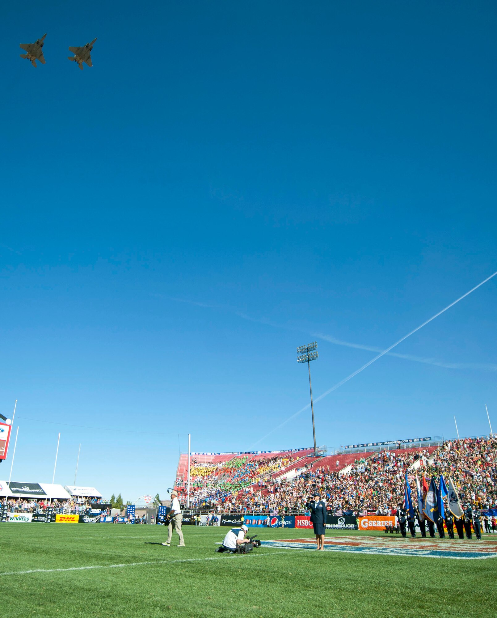Two F-15 Eagles assigned to the 422nd Test and Evaluation Squadron at Nellis Air Force Base, Nev., performed a fly over after the singing of the national anthem and presentation of the colors by the Nellis AFB Honor Guard during the U.S.A. Sevens Rugby tournament at the Sam Boyd Stadium, Las Vegas, Feb. 14, 2015. Las Vegas was one of nine stops in the Rugby Sevens World Series with it being the only stop in the U.S.A. (U.S. Air Force photo by Airman 1st Class Mikaley Towle) 