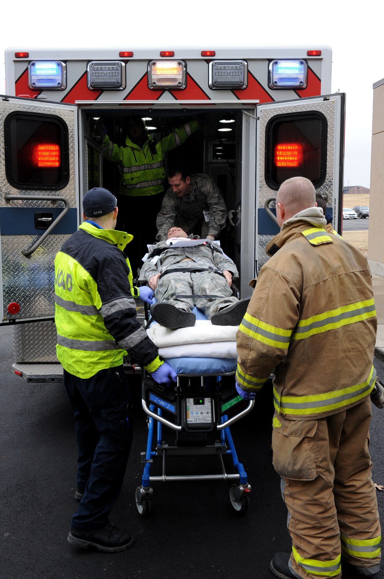 Senior Airman Derek Asbury, 509th Maintenance Group, is transported into the back of an ambulance during an active-shooter exercise at Whiteman Air Force Base, Mo., Feb. 11, 2015.  The Johnson County Ambulance District, from Warrensburg, Mo. also participated as local-civilian first responders during the exercise. (U.S. Air Force photo by Airman 1st Class Joel Pfiester/Released)