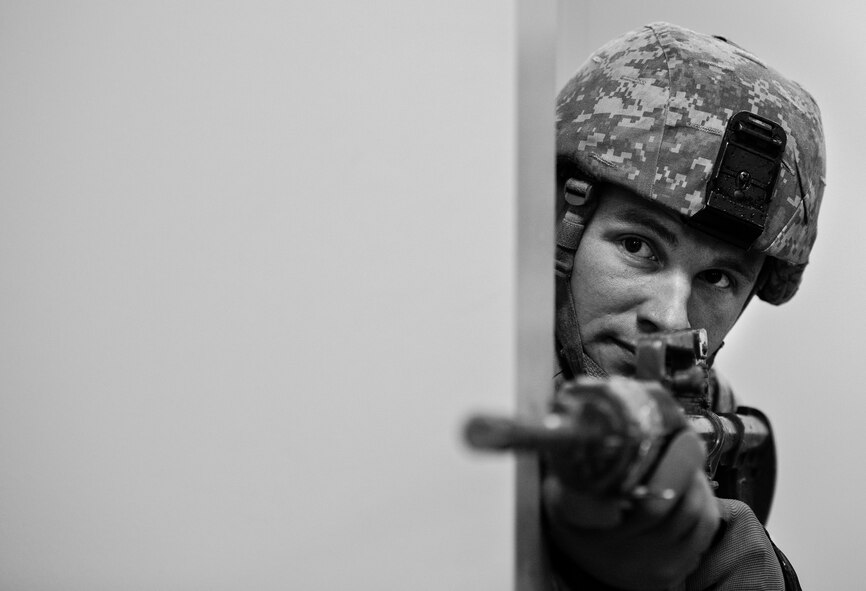 Airman 1st Class David Sutkus, 96th Security Forces Squadron, checks around a corner before advancing forward while searching the building during an active shooter exercise Feb. 4 at Duke Field, Fla. The Airmen entered the building to apprehend the suspect, assess the wounded and report back information to the emergency responders. (U.S. Air Force photo/Tech. Sgt. Samuel King)