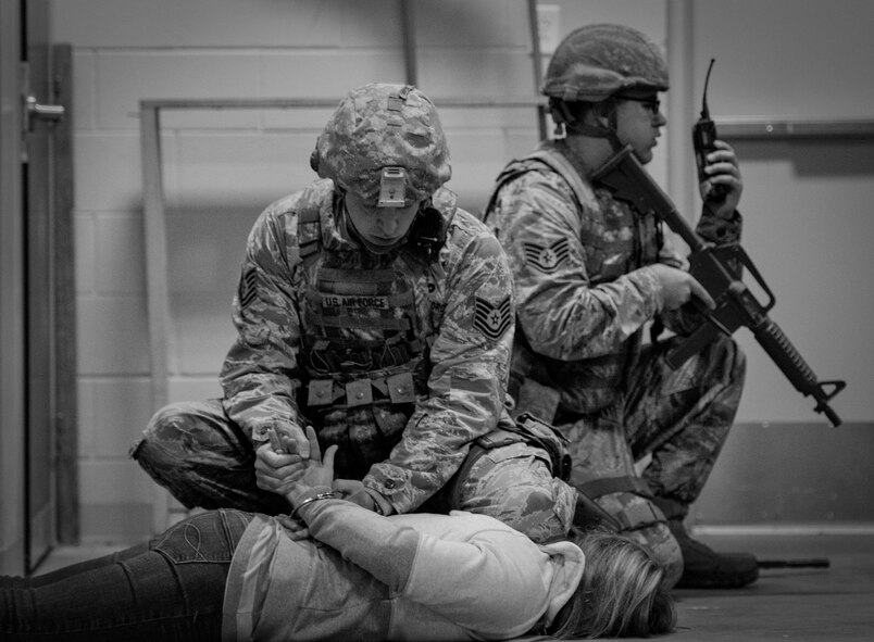 Tech. Sgt. Brent Young, 96th Security Forces Squadron, places handcuffs on the suspect during an active shooter exercise Feb. 4 at Duke Field, Fla. The Airmen entered the building to apprehend the suspect, assess the wounded and report back information to the emergency responders. (U.S. Air Force photo/Tech. Sgt. Samuel King)