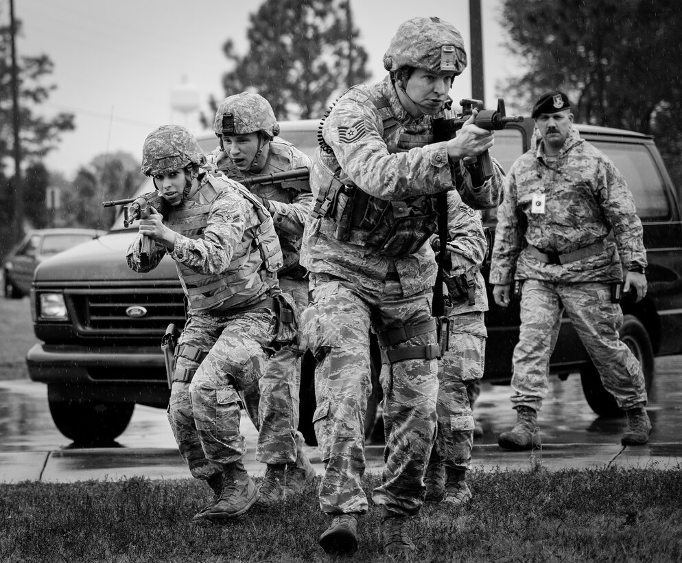 Airmen with the 96th Security Forces Squadron move toward the entrance of the building during an active shooter exercise Feb. 4 at Duke Field, Fla. The Airmen entered the building to apprehend the suspect, assess the wounded and report back information to the emergency responders. (U.S. Air Force photo/Tech. Sgt. Samuel King)