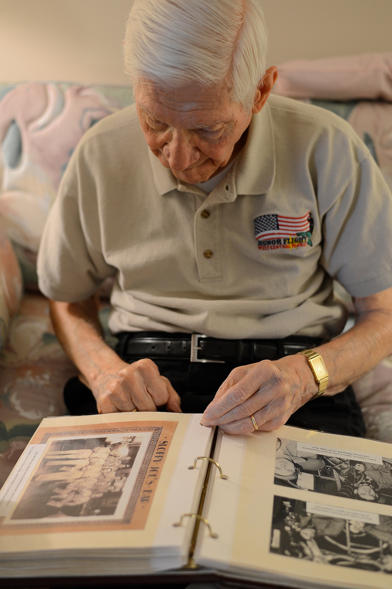 Russell Gackenbach, former B-29 Superfortress navigator, looks through a photo album, Feb 10, 2015, Clearwater, Fla.  Gackenbach was a part of the atomic bomb mission on Hiroshima, Japan on Aug. 6, 1945. (U.S. Air Force photo by Tech. Sgt. Brandon Shapiro/Released).