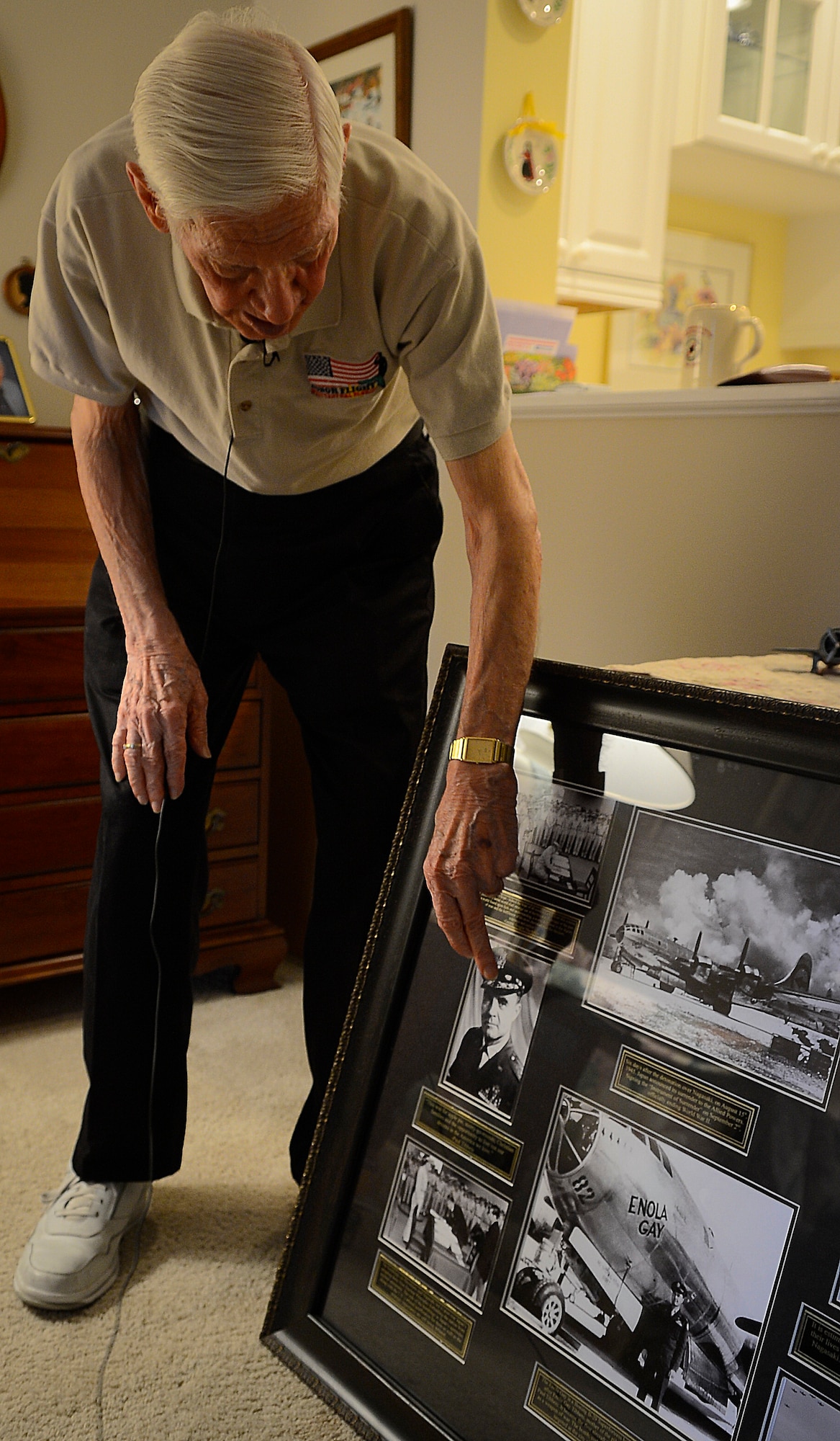 Russell Gackenbach, former B-29 Superfortress navigator, shows photographs from the bombing on Hiroshima, Japan, Feb 10, 2015, Clearwater, Fla.  Gackenbach is credited with taking some of the only photos of the first atomic bomb used in combat. (U.S. Air Force photo by Tech. Sgt. Brandon Shapiro/Released).