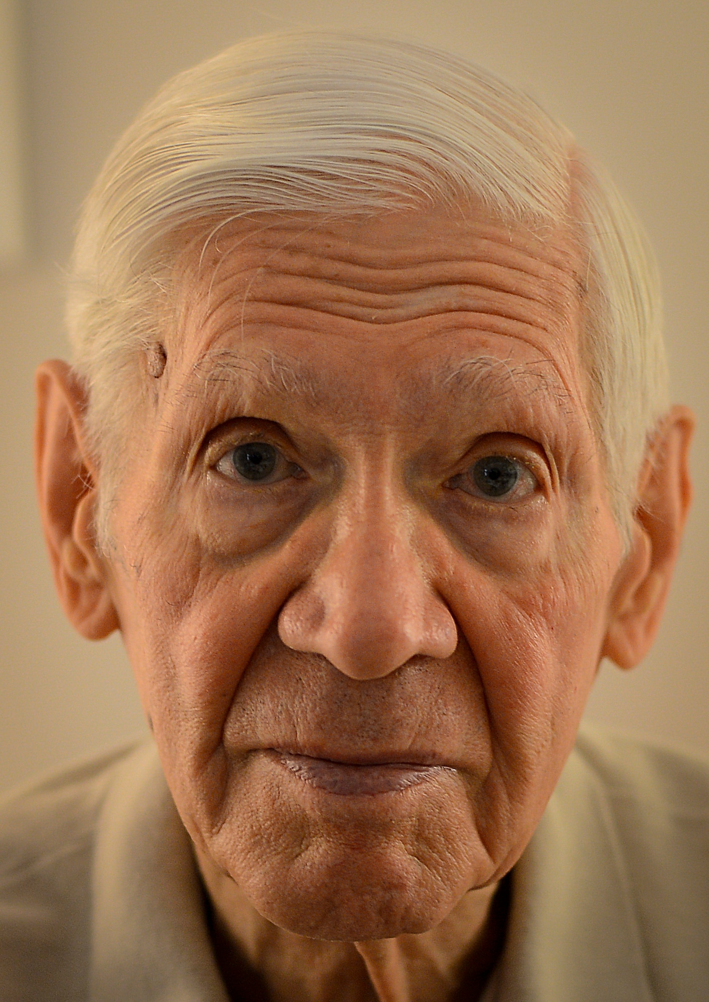 Pictured is Russell Gackenbach, the navigator aboard the B-29 Superfortress, Necessary Evil, during the nuclear bombing mission over Hiroshima, Japan on Aug. 6, 1945, shows a photo he took during the historic day, Clearwater, Fla., Feb 10, 2015.  Gackenbach is the last surviving member from the mission. (U.S. Air Force photo by Tech. Sgt. Brandon Shapiro/Released).