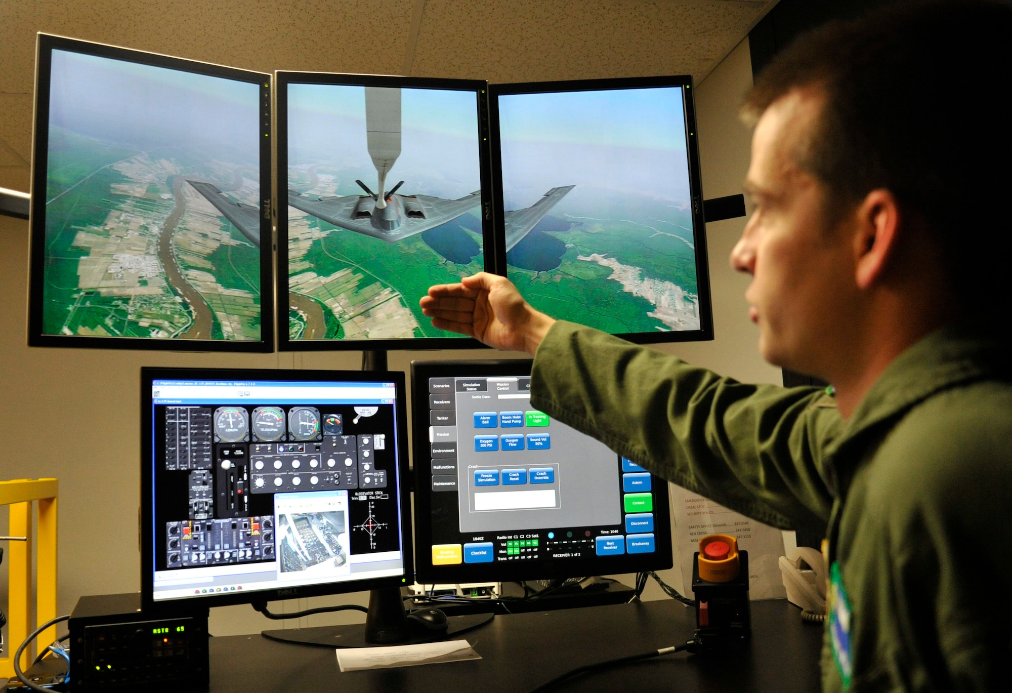 Staff Sgt. Michael Weidman, 92nd Operations Support Squadron instructor boom operator, shows the screens of the operating station for the Boom Operator Weapon System Trainer Feb. 17, 2015, at Fairchild Air Force Base, Wash. The operating station controls the type of aircraft for refueling as well as viewing the boom instruments during simulation practices. (U.S. Air Force photo/Airman 1st Class Nicolo J. Daniello)
