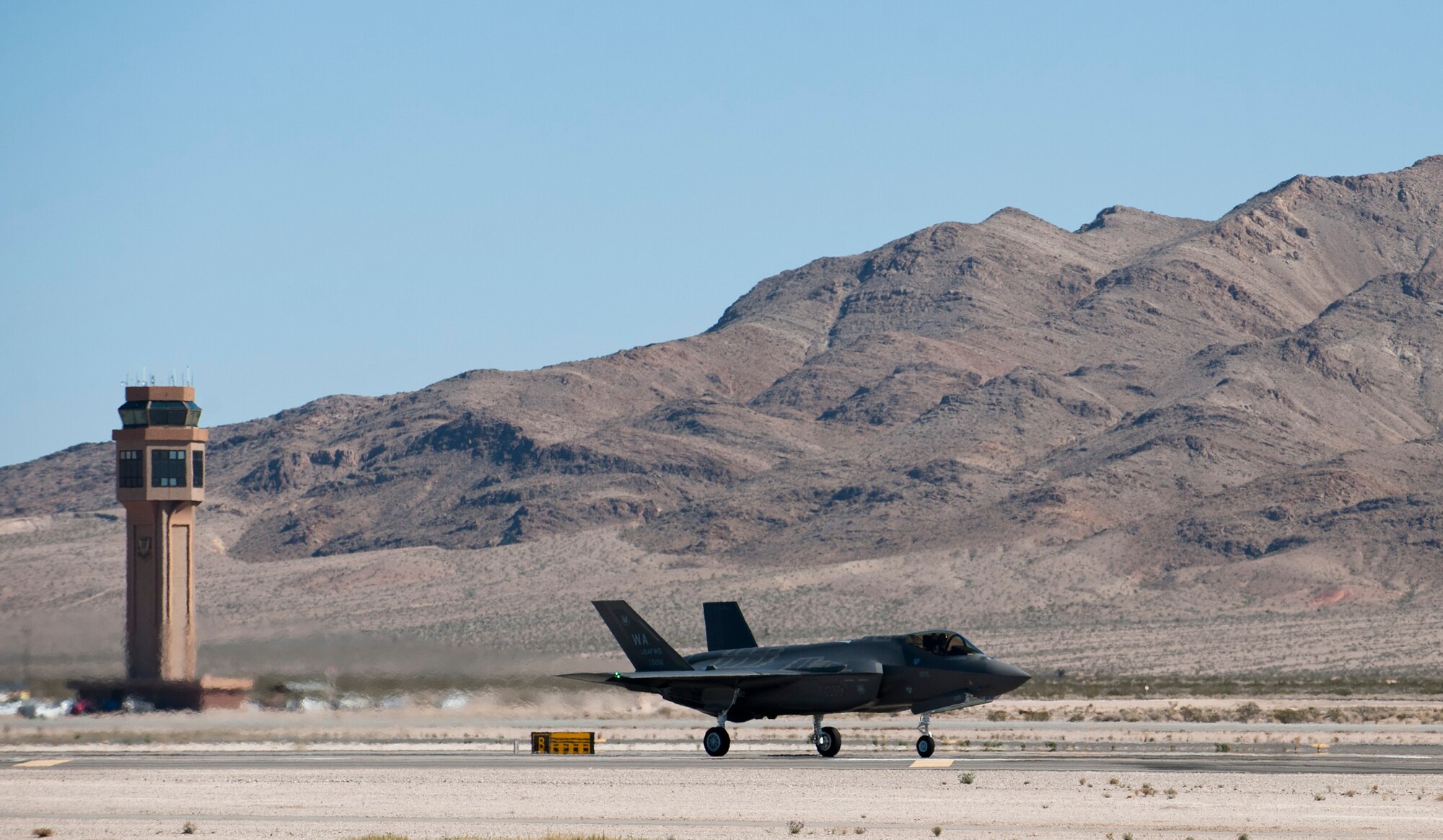 The second F-35 Lightning II assigned to the U.S. Air Force Weapons School lands at Nellis Air Force Base, Nev., Feb. 18, 2015. The integration of the F-35 into the syllabus will better prepare Weapons School students for future conflicts, as well as increase the effectiveness of other combat aircraft. (U.S. Air Force photo by Senior Airman Thomas Spangler)