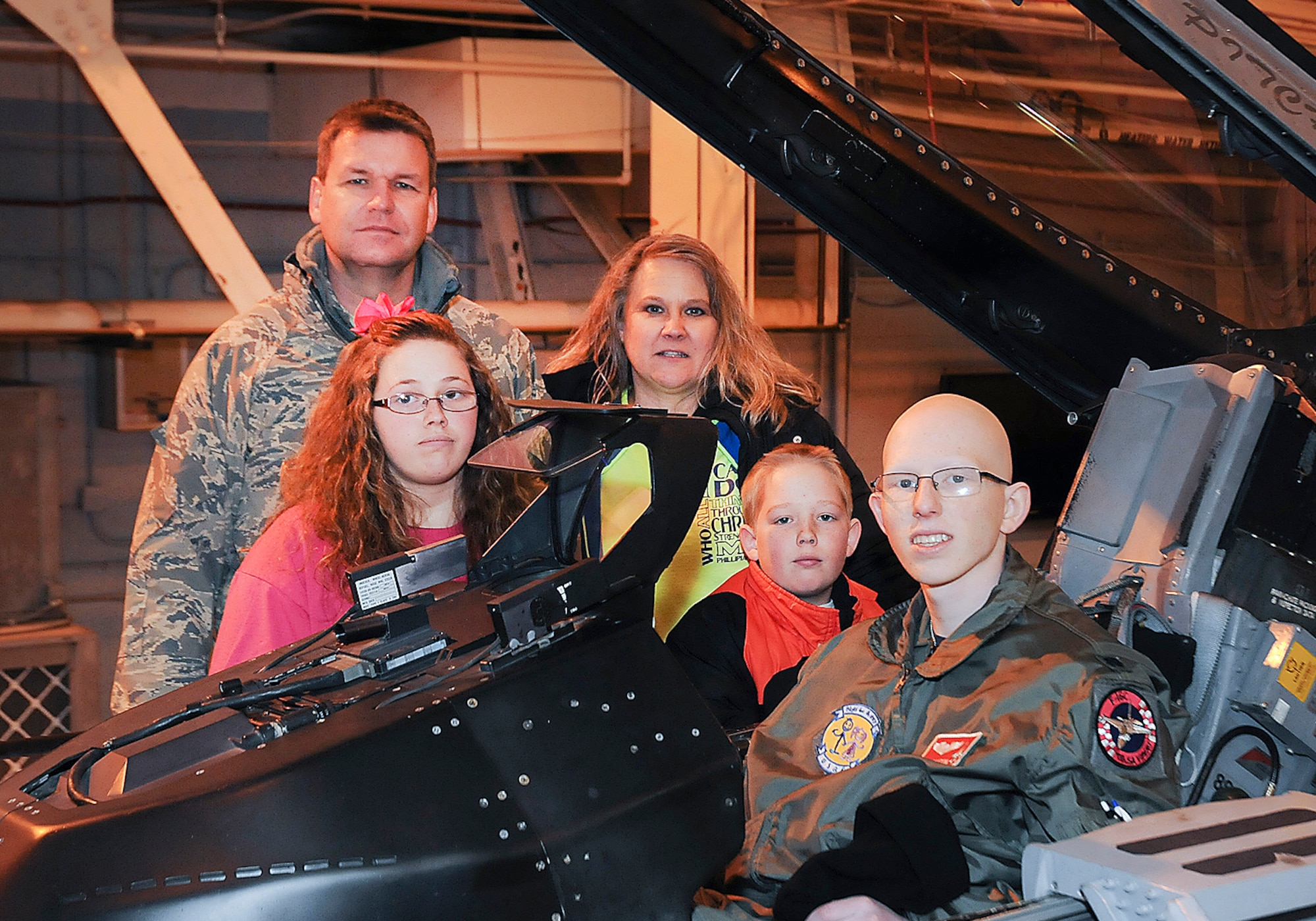 Josh Payton, 138th Fighter Wing's "pilot for a day" with parents A1C Jacky Payton and wife Marie, sister Gracie and brother Jared during his visit as an honored guest Feb. 19, 2015, at the Tulsa Air National Guard base, Tulsa, Okla.  The pilot for a day program is intended to recognize and honor children with potentially life threatening illnesses and started at the 138th in May 2012, and has hosted seven children since it began.  (U.S. National Guard photo by Senior Master Sgt.  Preston L. Chasteen/Released)