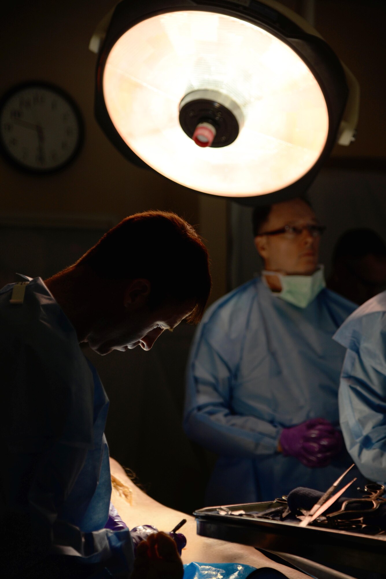 U.S. Air Force Maj. (Dr.) Cale Bonds, foreground, practices a surgical procedure during an Emergency War Surgery Course Feb. 11, 2015 at the Wilford Hall Ambulatory Surgical Center, JBSA-Lackland, San Antonio, Texas. Formerly known as the Trauma Refresher Course for Surgeons, the course was created as a way to standardize medical training for surgeons and nurses in all military services. Bonds is an orthopedic surgeon currently stationed at Travis Air Force Base. (U.S. Air Force photo/Staff Sgt. Jerilyn Quintanilla)