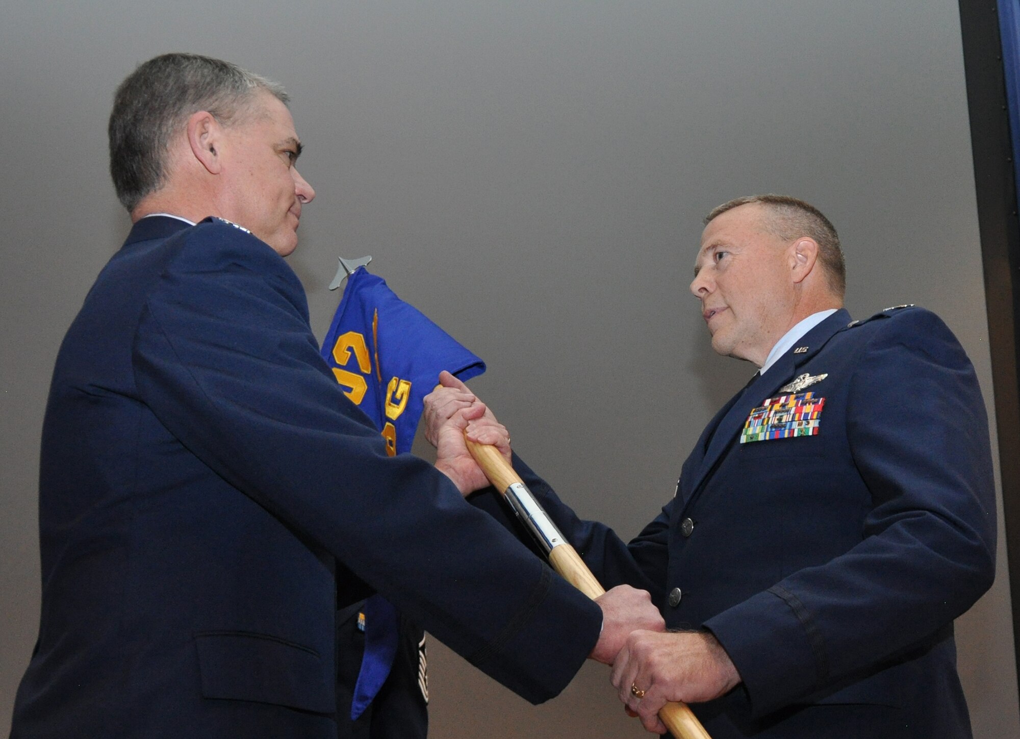 PETERSON AIR FORCE BASE, Colo. – Col. Robert Stanton, right accepts the 302nd Operations Group guideon from Col. Jay Pittman.  Stanton assumed command of the 302nd Operations Group during a ceremony here Feb. 19, 2015. He said he is coming into the position with three expectations: to give 100 percent, to use innovation in these challenging times, and the need to have fun, as Airmen are young, flying in the Air Force, and need to enjoy the moment. This will be Stanton’s second wing with a special mission. His last position was the Deputy Commander of the 403rd Operations Group, Keesler AFB, Miss. which has the “Hurricane Hunters” aerial weather reconnaissance mission. The 302nd Operations Group is home to the only Reserve wing with an aerial firefighting mission. Pittman, 302nd Airlift Wing Commander, was the presiding official of the ceremony. (U.S. Air Force photo/Master Sgt. Daniel Butterfield)