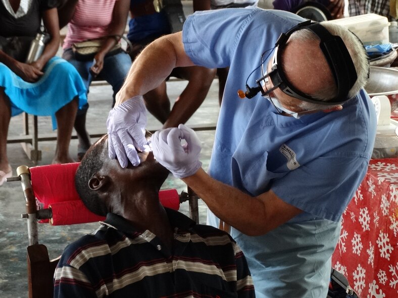 Col. Victor Brown, commander, 914th Aeromedical Staging Squadron, performs dental care on a patient during a recent trip to the Macieux region of the Republic of Haiti. Brown traveled to Haiti as part of a humanitarian visit. (Courtesy photo by Maj. Stanley Michel)