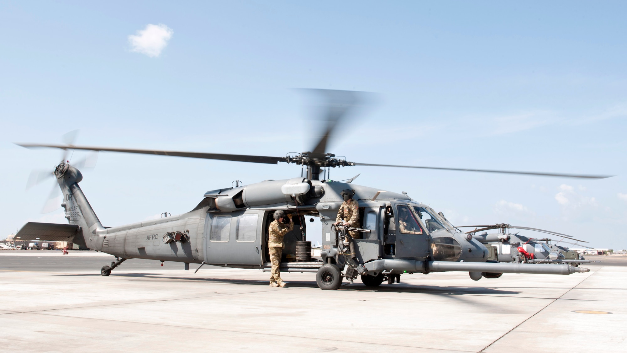 Members from the 303rd Expeditionary Rescue Squadron prepare to initiate a hoist weight check at Camp Lemonnier, Djibouti, Jan. 26, 2015. The hoist was recently repaired and was checked for serviceability with a max weight of 600 pounds. (U.S. Air Force photo by Staff Sgt. Kevin Iinuma) 
