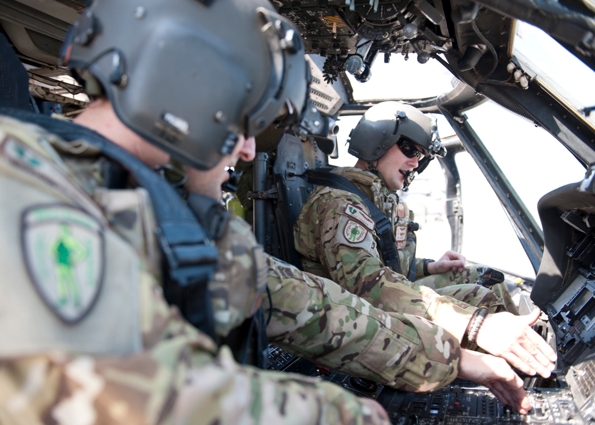 U.S. Air Force 1st Lt Michael Parker (left) and Capt. Brandon Fesko, both 303rd Expeditionary Rescue Squadron pilots, inspect the control panels during a preflight check at Camp Lemonnier, Djibouti on Jan. 26, 2015. A preflight is held every three days when the team is on alert, to ensure everything is in working order and ready to fly. (U.S. Air Force photo by Staff Sgt. Kevin Iinuma) 