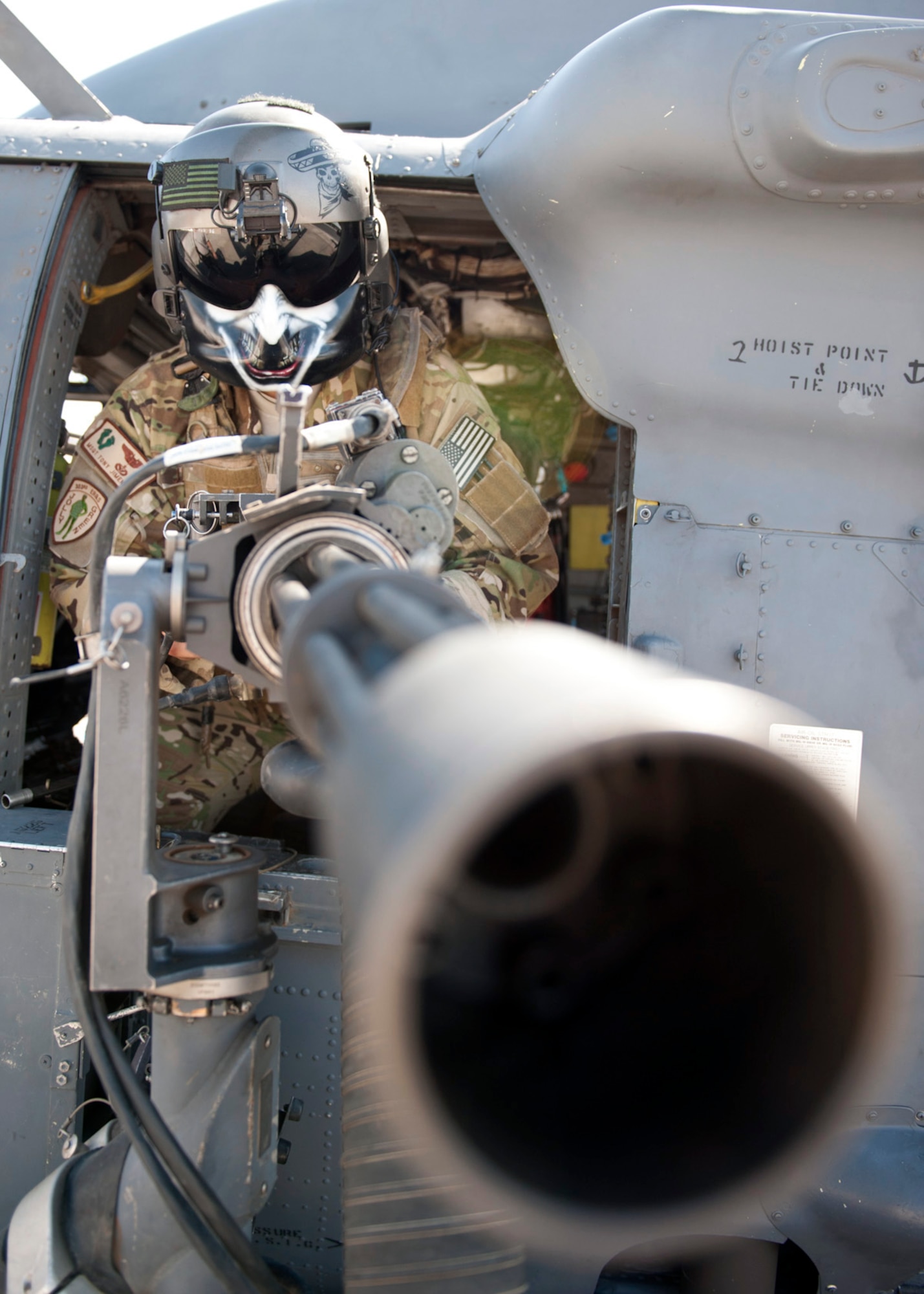 U.S. Air Force Master Sgt. Antonio Jimenez, 303rd Expeditionary Rescue Squadron special mission aviator, simulates ‘stand ready’ with the GAU-2 mini-gun at Camp Lemonnier, Djibouti on Jan. 26, 2015. This position is taken if and when they need to provide combat air support during any rescue mission. (U.S. Air Force photo by Staff Sgt. Kevin Iinuma) 
