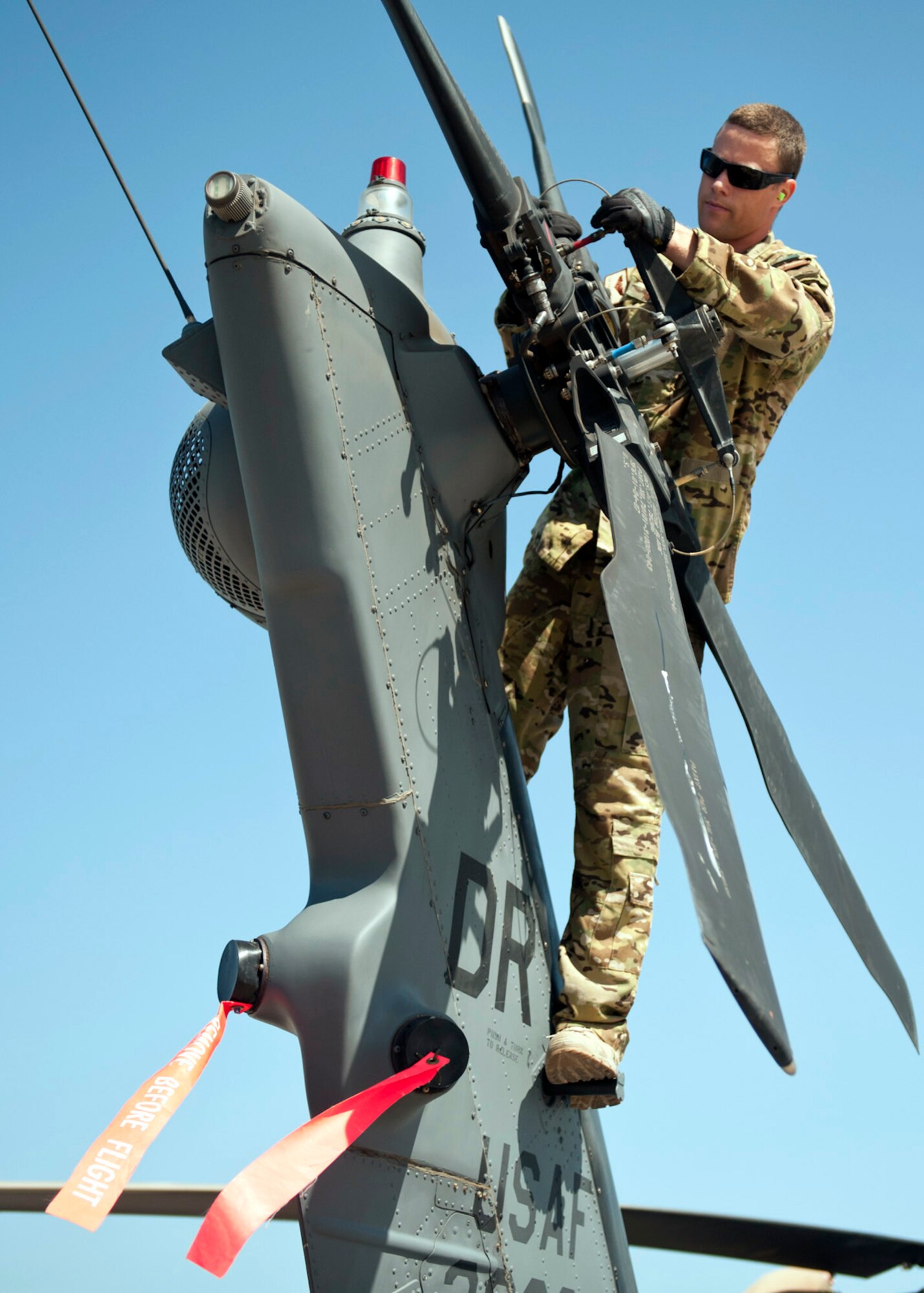 U.S. Air Force Tech. Sgt. Caleb Hiner, 303rd Expeditionary Rescue Squadron special mission aviator, inspects the tail motor on an HH-60 Pave Hawk during a preflight inspection at Camp Lemonnier, Djibouti on Jan. 26, 2015. During the preflight checks, the aviators look for serviceability and to ensure the aircraft is ready to fly when they are called for a mission. (U.S. Air Force photo by Staff Sgt. Kevin Iinuma) 