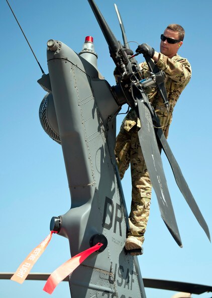U.S. Air Force Tech. Sgt. Caleb Hiner, 303rd Expeditionary Rescue Squadron special mission aviator, inspects the tail motor on an HH-60 Pave Hawk during a preflight inspection at Camp Lemonnier, Djibouti on Jan. 26, 2015. During the preflight checks, the aviators look for serviceability and to ensure the aircraft is ready to fly when they are called for a mission. (U.S. Air Force photo by Staff Sgt. Kevin Iinuma) 