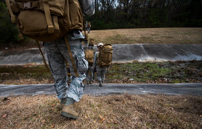 Airmen from the 1st Combat Camera Squadron at Joint Base Charleston, S.C., participate in a ruck march Jan. 29, 2015, in preparation for their annual validation exercise which evaluates their ability to survive and operate in an austere environment. This ruck was dedicated to former 1 CTCS commander, Col. Aaron Burgstein, who passed away Jan. 27, 2015. Burgstein commanded the squadron from July 2009 to July 2012. (U.S. Air Force photo by Senior Airman Marianique Santos/Released)