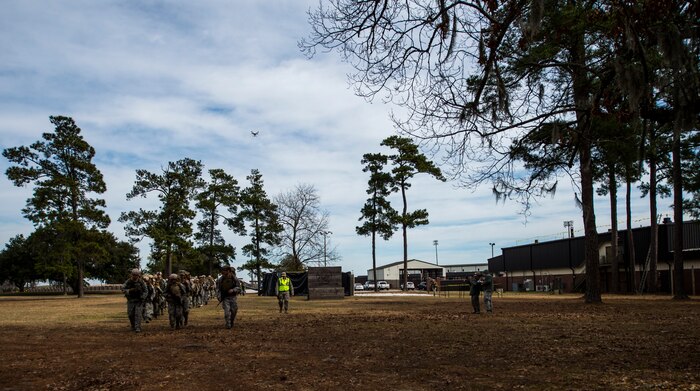 Airmen from the 1st Combat Camera Squadron at Joint Base Charleston, S.C., participate in a ruck march Jan. 29, 2015, in preparation for their annual validation exercise which evaluates their ability to survive and operate in an austere environment. This ruck was dedicated to former 1 CTCS commander, Col. Aaron Burgstein, who passed away Jan. 27, 2015. Burgstein commanded the squadron from July 2009 to July 2012. (U.S. Air Force photo by Senior Airman Marianique Santos/Released)