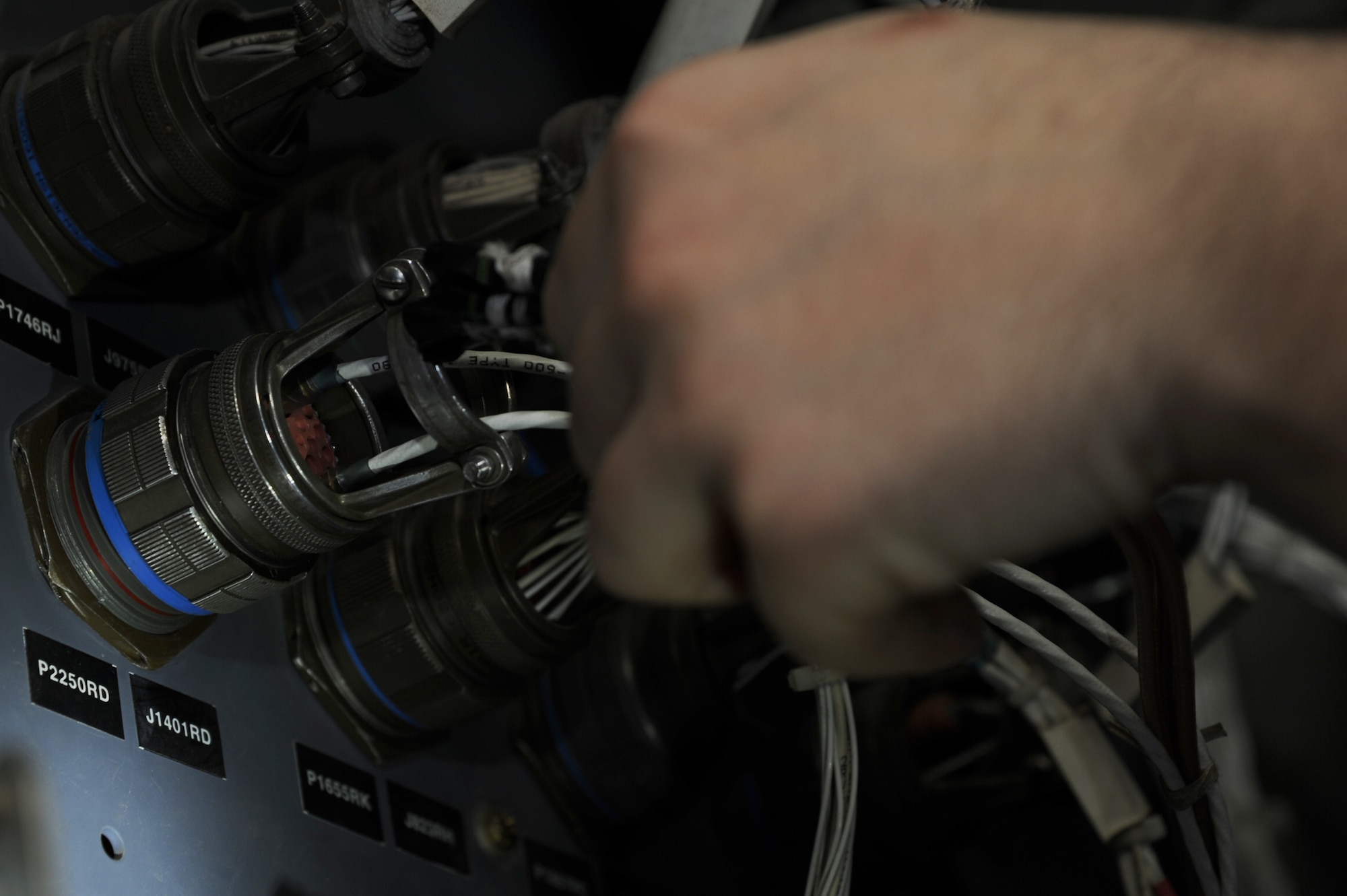 Airman 1st Class Devin Brown, a 19th Aircraft Maintenance Squadron communication countermeasures navigations systems journeyman, secures a canon plug Feb. 5, 2015 at Little Rock Air Force Base, Ark. Without the canon plug, the aircraft’s navigational systems could not function properly. (U.S. Air Force photo by Airman 1st Class Mercedes Muro) 