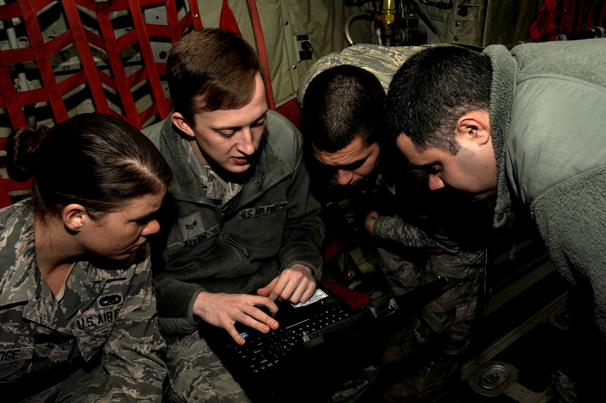 Airmen from the 19th Aircraft Maintenance Squadron communication countermeasures navigations systems flight collaborate before performing a repair Feb. 4, 2015, at Little Rock Air Force Base, Ark. Airmen employed in the COM/NAV flight work together to make repairs and keep aircraft navigation systems up and running. (U.S. Air Force photo by Airman 1st Class Mercedes Muro) 