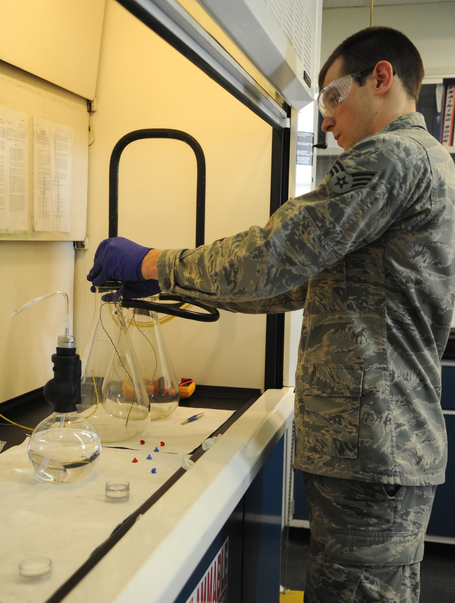 Senior Airman Noah Lazurka, 4th Logistics Readiness Squadron fuels laboratory technician, tests fuel using single weight pads at Seymour Johnson Air Force Base, North Carolina, Feb. 11, 2014. Single weight pads provide data on a fuel’s color and particulates. (U.S. Air Force photo/Senior Airman Ashley J. Thum)