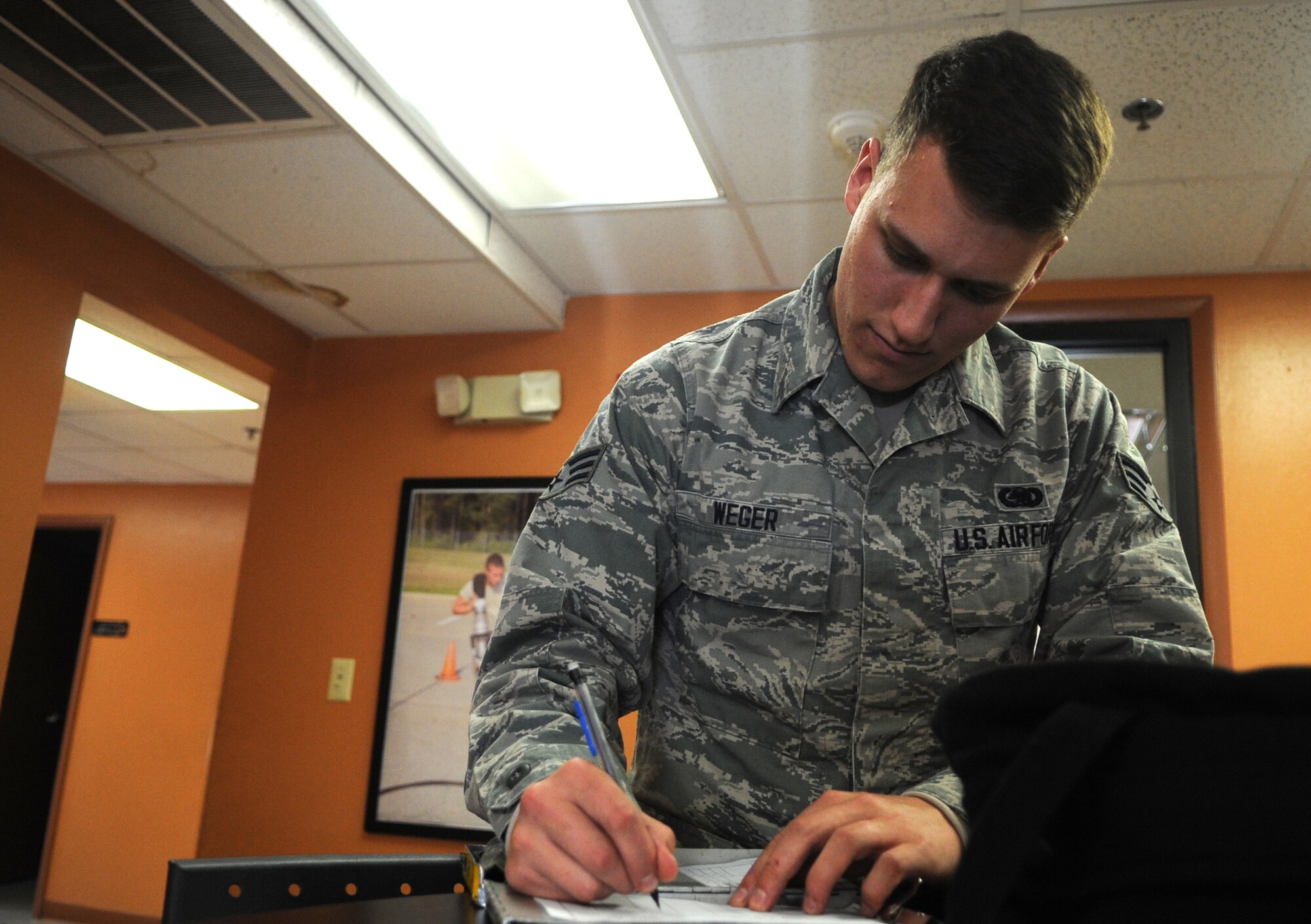 Senior Airman Mitchell Weger, 4th Logistics Readiness Squadron fuels distribution operator, reviews the clipboard for a fuel truck prior to leaving for a refueling run at Seymour Johnson Air Force Base, North Carolina, Feb. 11, 2015. Operators are on hand 24 hours a day to quickly respond to calls for fuel.  (U.S. Air Force photo/Senior Airman Ashley J. Thum)