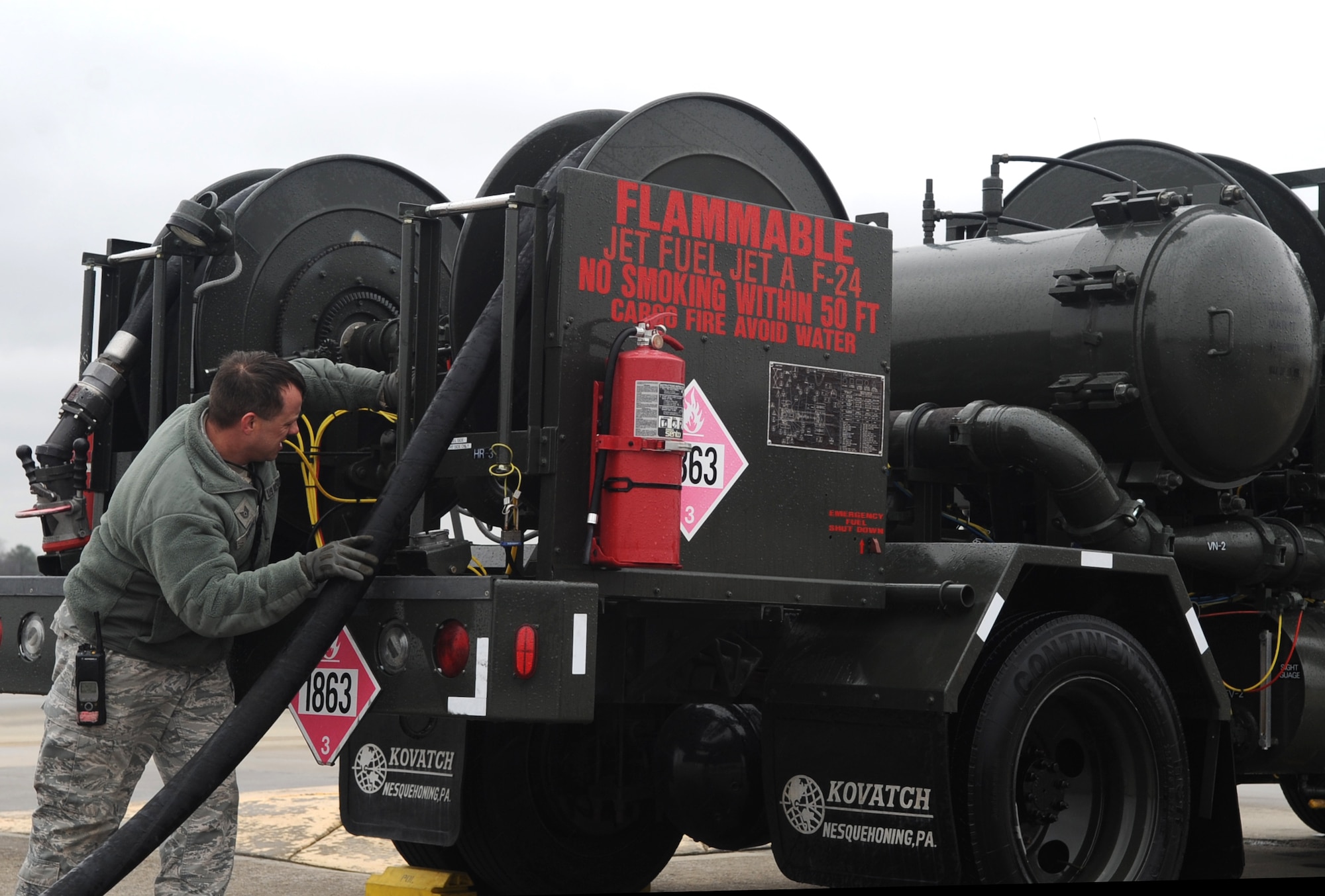 Tech. Sgt. Geoffrey Nowell, 4th Logistics Readiness Squadron fuels distribution NCO in charge, rolls up the hose on a fuel truck after a hot pit refuel at Seymour Johnson Air Force Base, North Carolina, Feb. 10, 2015. Airmen from the 4th LRS Petroleum, Oil and Lubricants shop assist maintenance crews with accomplishing hot pit refueling operations. (U.S. Air Force photo/Senior Airman Ashley J. Thum)