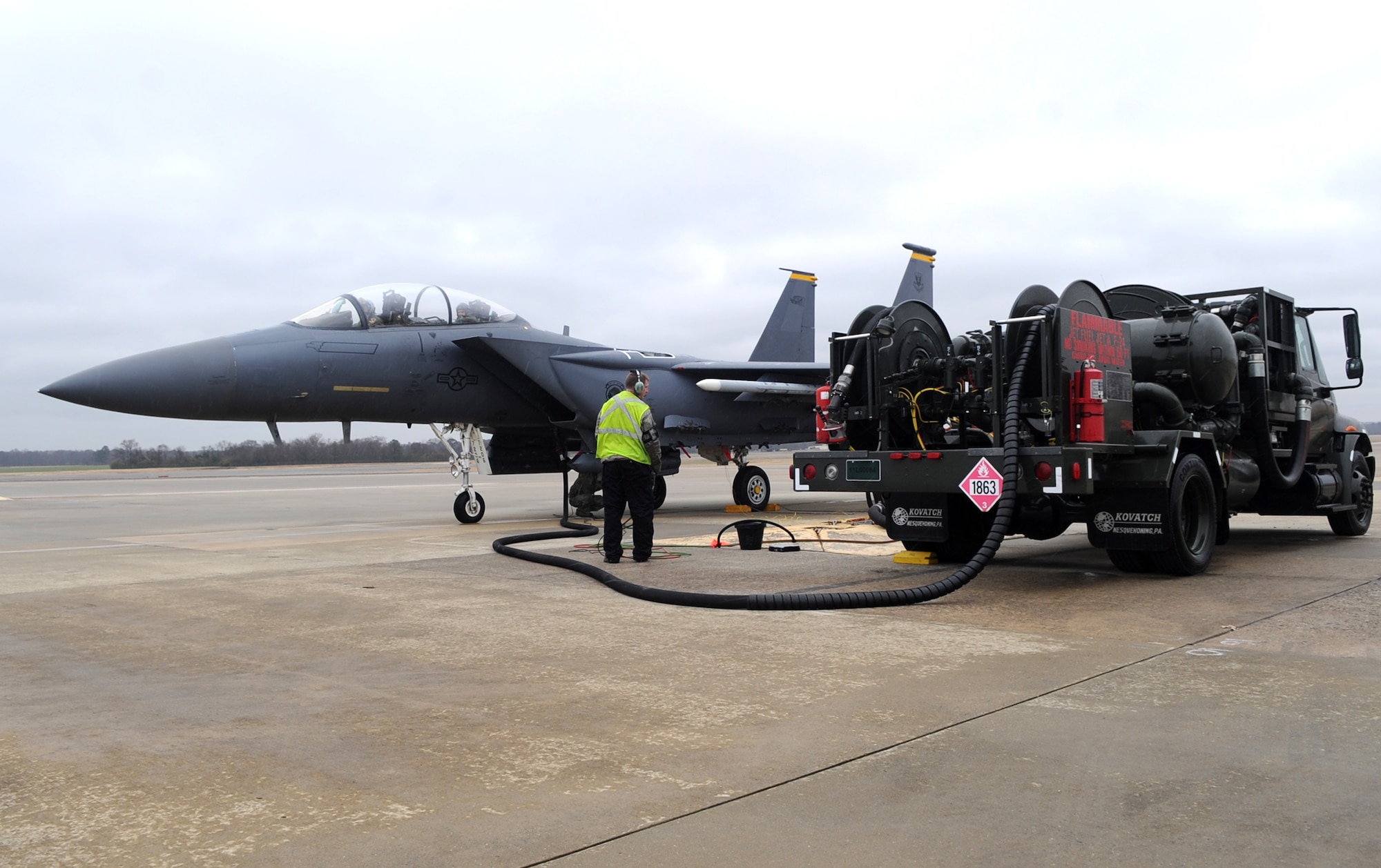 Airmen from the 335th Aircraft Maintenance Unit and the 4th Logistics Readiness Squadron perform a hot pit refuel on an F-15E Strike Eagle from the 335th Fighter Squadron at Seymour Johnson Air Force Base, North Carolina, Feb. 10, 2015. Petroleum, Oil and Lubricants Airmen provide the fuel trucks for hot pit refueling operations and monitor the process. (U.S. Air Force photo/Senior Airman Ashley J. Thum)