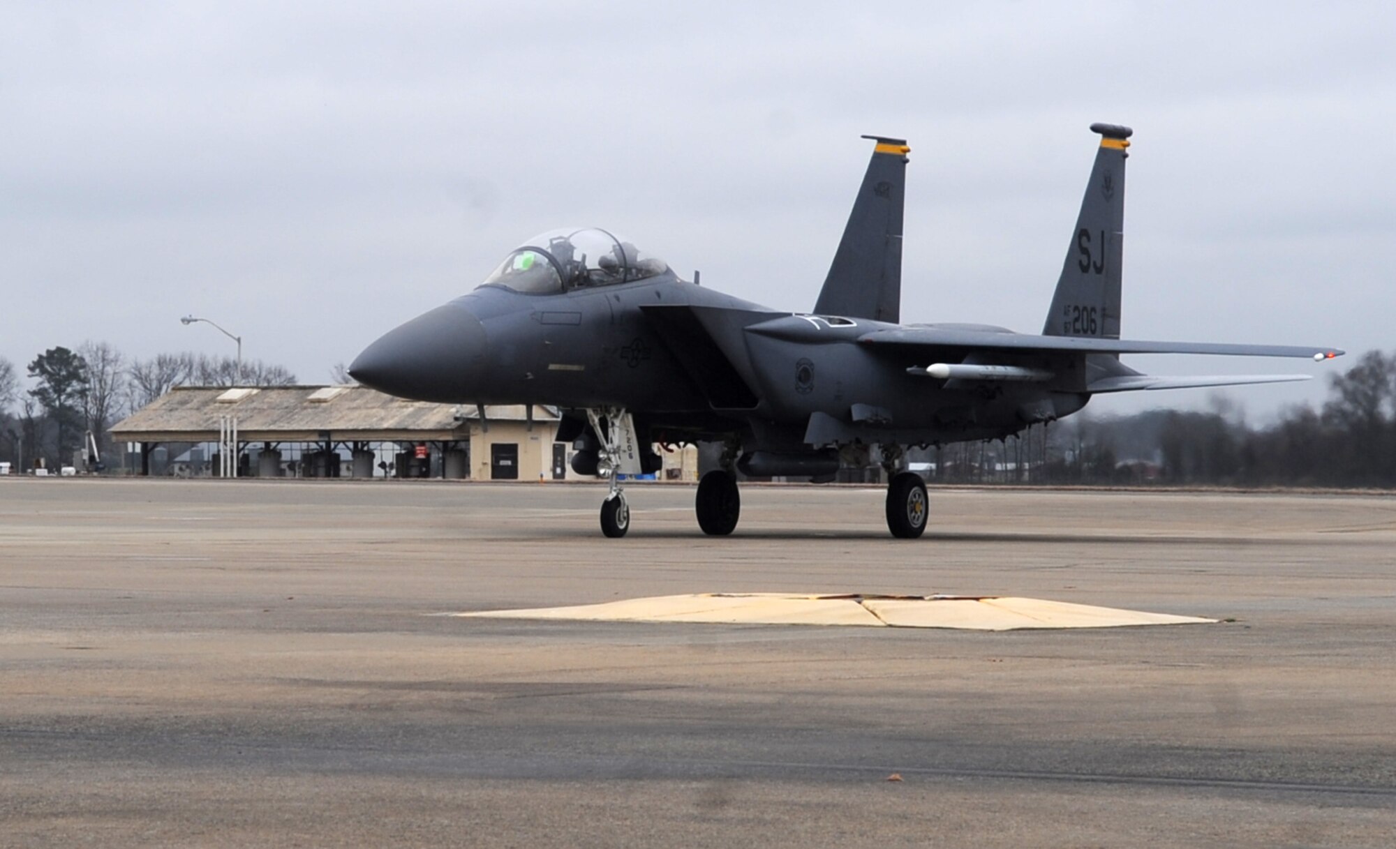 An F-15E Strike Eagle from the 335th Fighter Squadron idles before approaching a hot pit refueling area at Seymour Johnson Air Force Base, North Carolina, Feb. 10, 2015. Hot pit refuels are different from normal refueling operations because the aircraft’s engines remain on during the process. (U.S. Air Force photo/Senior Airman Ashley J. Thum)
