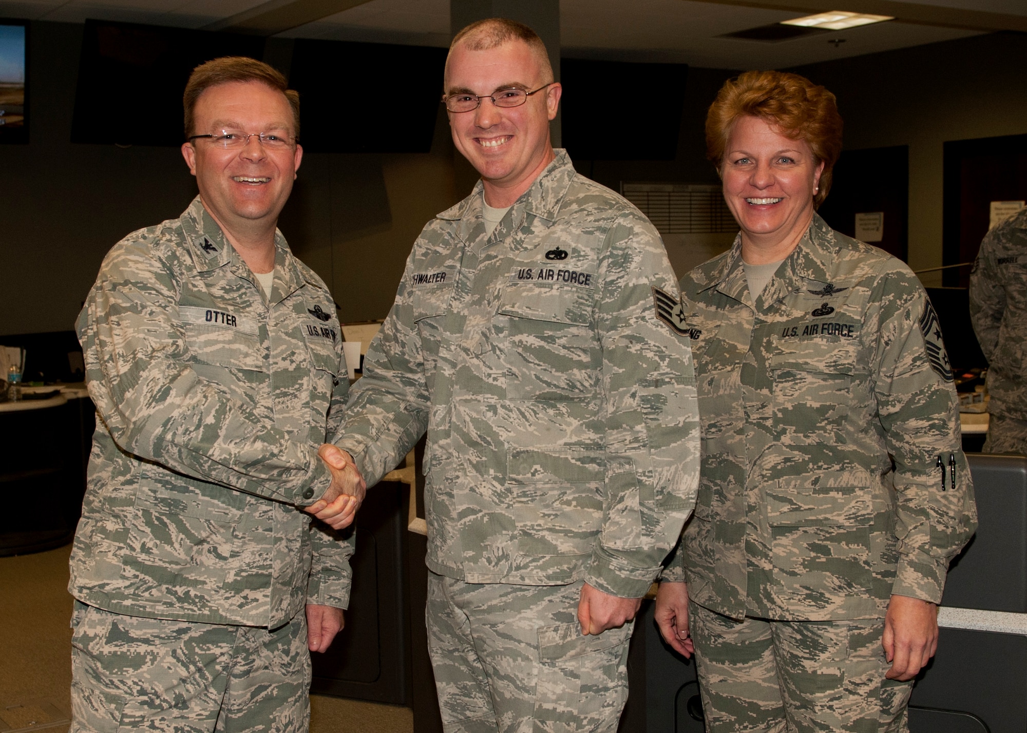 Col. William Otter, 19th Airlift Wing vice commander, along with Chief Master Sgt. Rhonda Buening, 19th AW command chief, congratulate Staff Sgt. Brandon Buchwalter, a 19th Maintenance Group weapons systems coordinator, on his selection as the Combat Airlifter of the Week Feb. 17, 2015, at Little Rock Air Force Base, Ark. Buchwalter’s leadership as a senior weapons systems coordinator was vital to tracking and reporting three major command’s completion of 1,400 flying hours and 840 sorties. (U.S. Air Force photo by Airman 1st Class Scott Poe)