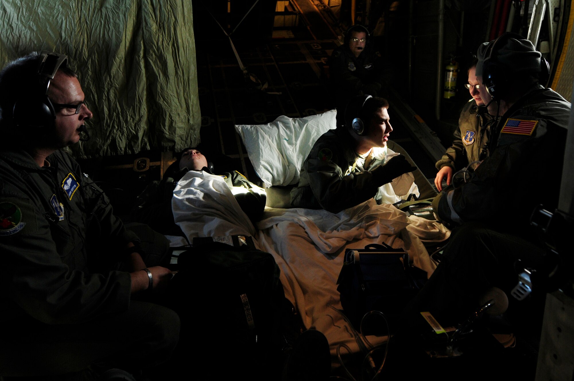 Members of the 156th Aeromedical Evacuation Squadron treat a simulated patient for nausea during an aeromedical training mission roundtrip from North Carolina Air National Guard Base, Charlotte Douglas Intl. Airport, Jan. 9, 2015. The training mission scenario is to transfer patients from Landstuhl Medical Center, Germany, to Malcolm Grove Medical Center, Md. The simulated patient demonstrated symptoms consistent with nausea. (U.S. Air National Guard photo by Staff Sgt. Julianne M. Showalter, 145th Public Affairs/ Released)