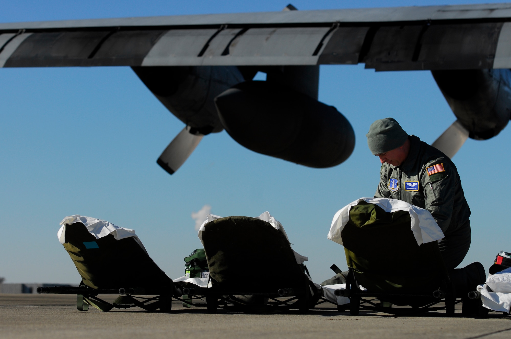U.S. Air Force 1st Lt. Shawn Griffin, 156th Aeromedical Evacuation Squadron, readies litters for patients during an aeromedical training mission at the North Carolina Air National Guard Base, Charlotte Douglas Intl. Airport, Jan. 9, 2015. The training mission scenario is to transfer patients from Landstuhl Medical Center, Germany, to Malcolm Grove Medical Center, Md. (U.S. Air National Guard photo by Staff Sgt. Julianne M. Showalter, 145th Public Affairs/ Released)