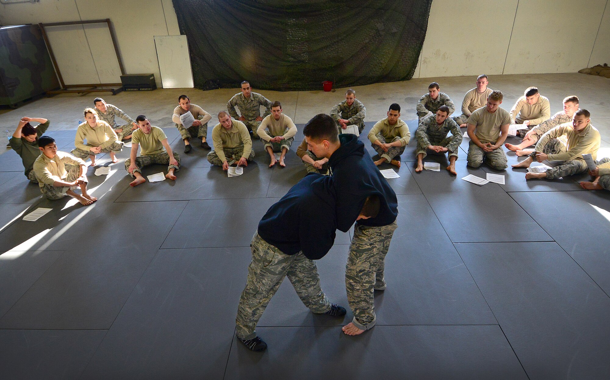 U.S. Air Force Staff Sgt. Bryan Meraz and Senior Airman Jakob Hasse, 435th Security Forces Squadron combatives instructors, teach a training course to 31 SFS Airmen, Feb. 18, 2015, at Aviano Air Base, Italy. Completion of the course will allow 20 of Aviano’s defenders to take the training they learned and teach it to the rest of the 31 SFS. (U.S. Air Force photo by Senior Airman Matthew Lotz/Released)