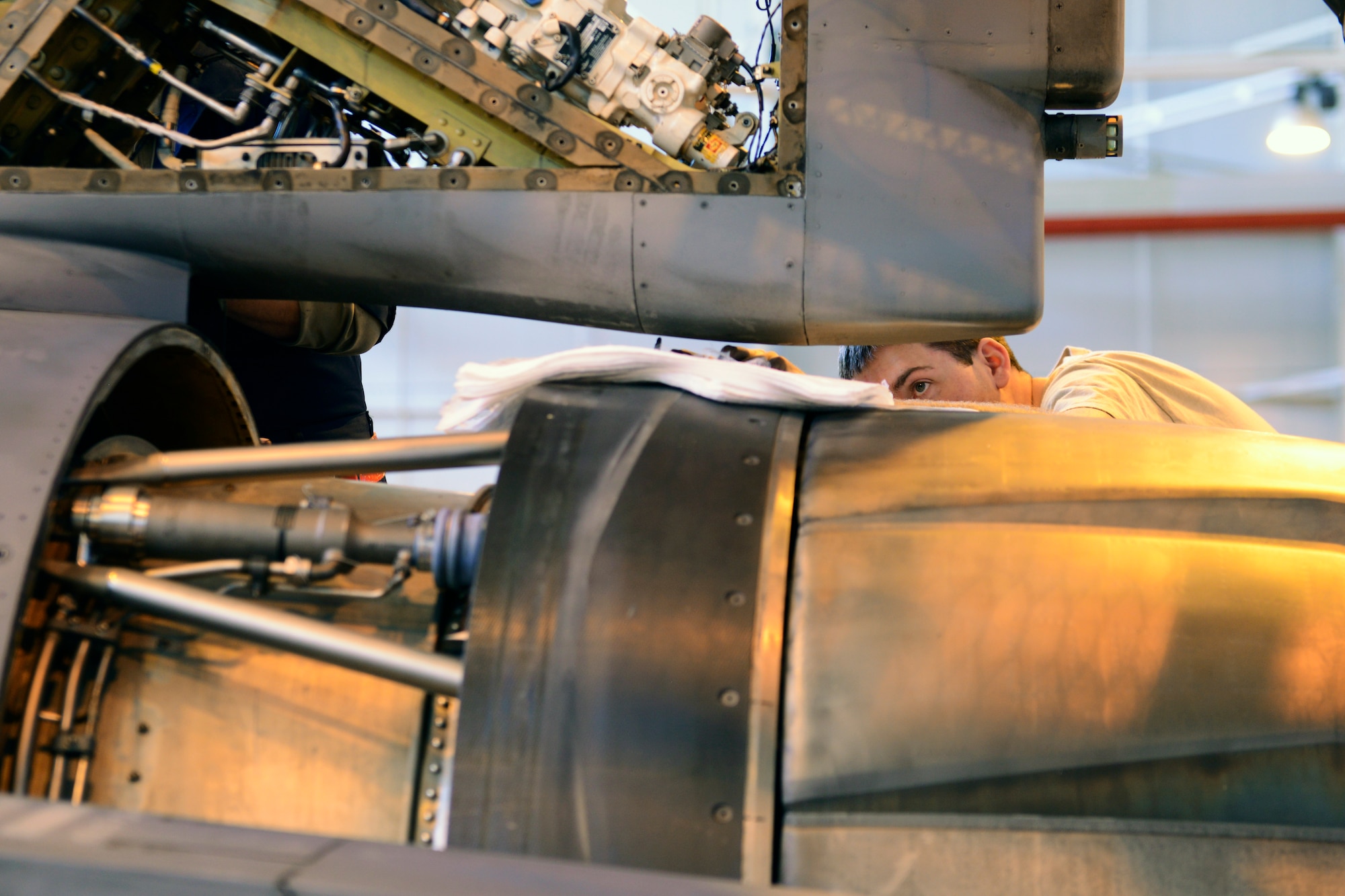 U.S. Air Force Senior Airman Cole Hammer, 31st Aircraft Maintenance Squadron phase inspection maintainer, dismantles a tail panel of an F-16 Fighting Falcon, Feb. 17, 2015, at Aviano Air Base, Italy. During a phase inspection, team members check all aircraft components, including landing and cockpit gear, as well as electrical, avionics and weapons systems. (U.S. Air Force photo/Airman 1st Class Ryan Conroy) 