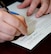 A U.S. Air Force Airman fills out his details as part of required paperwork to be added to the bone marrow donor registry Jan. 13, 2015, on RAF Mildenhall, England. Four swabs are taken from inside the cheeks and carefully packaged with relevant paperwork, before being sent to be tested by a laboratory, so potential donors’ names can be added to the registry. A bone marrow drive is scheduled for Feb. 23 to 28 on RAF Mildenhall and RAF Lakenheath. (U.S. Air Force photo by Karen Abeyasekere/Released) (Photo altered for security purposes)