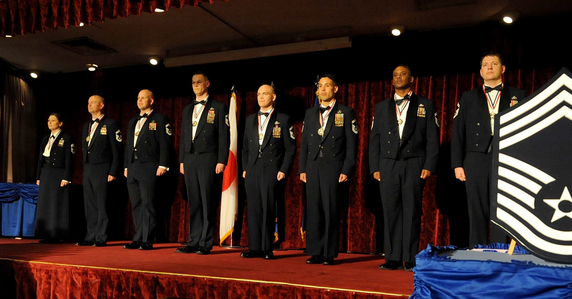 Eight senior master sergeants recently selected for promotion to chief master sergeant stand at attention at the end of their chief recognition ceremony at Kadena Air Base, Japan, Feb. 13, 2015. The ceremony was held to celebrate the huge accomplishment it is to reach the rank of chief master sergeant. (U.S. Air Force photo by Airman 1st Class Zackary A. Henry)