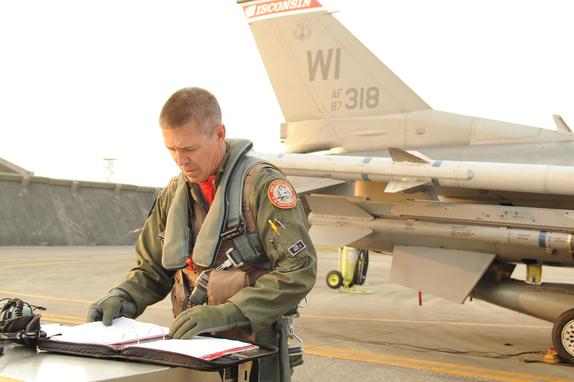 U.S. Air Force Lt. Col. Matthew C. McCunn, Wisconsin Air National Guard, 115th Fighter Wing pilot, prepares for his flight at Kadena Air Base, Japan, Feb. 13, 2015. McCunn reached a career total of 3,000 flying hours while deployed to Kadena during a joint training mission with the 18th Wing. (U.S. Air Force photo by Airman 1st Class Zackary A. Henry)