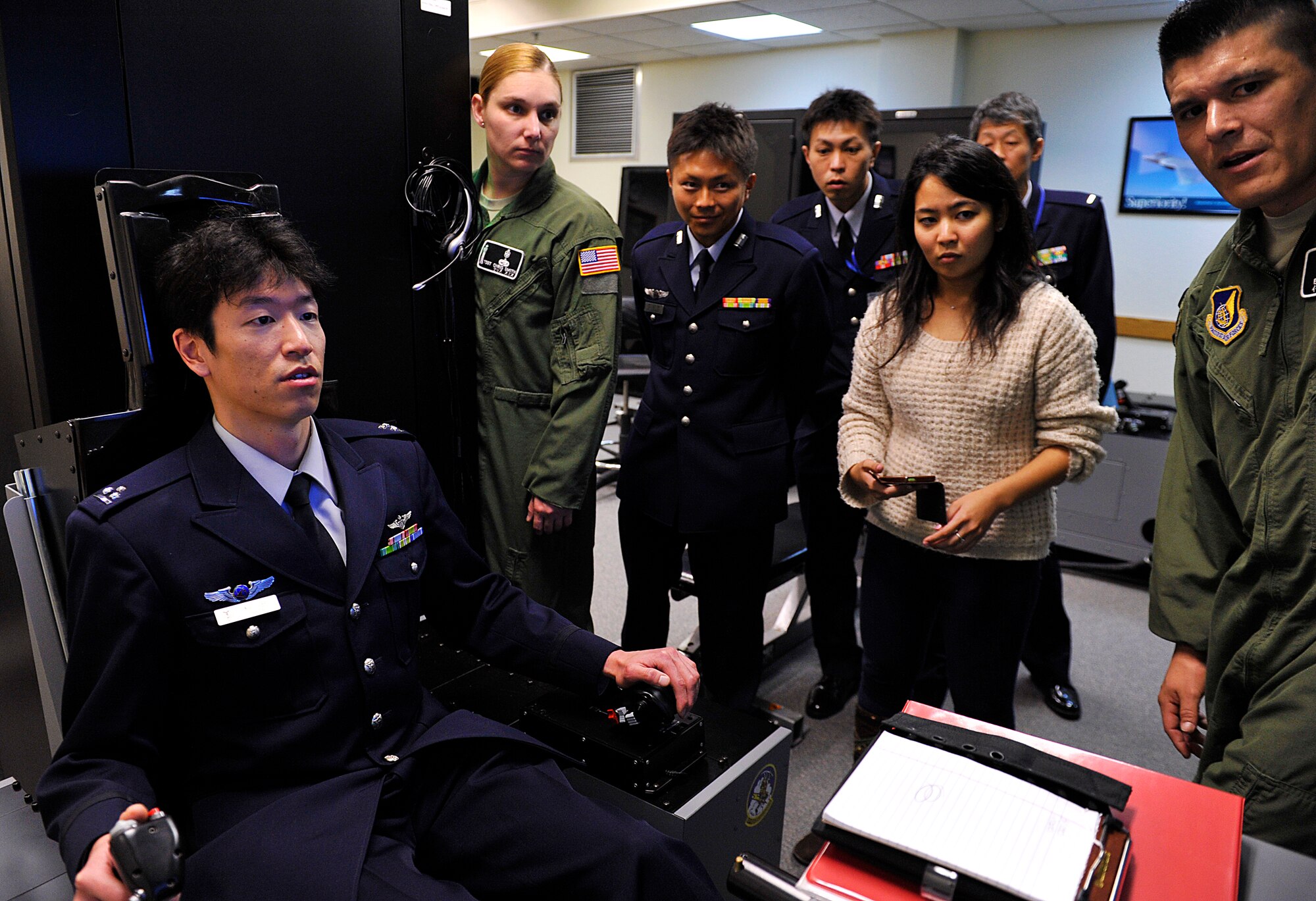 Japan Air Self-Defense Force Capt. Makoto Inada, 4th Division, Aeromedical Laboratory flight surgeon, participates in the demonstration of a Hypoxia Familiarization Trainer on Kadena Air Base, Japan, Feb. 12, 2015. The JASDF Aeromedical Laboratory personnel perform aviation-related medical and psychological research, physiological training and physical examination of aircrew, and support technical research and development. (U.S. Air Force photo by Naoto Anazawa)