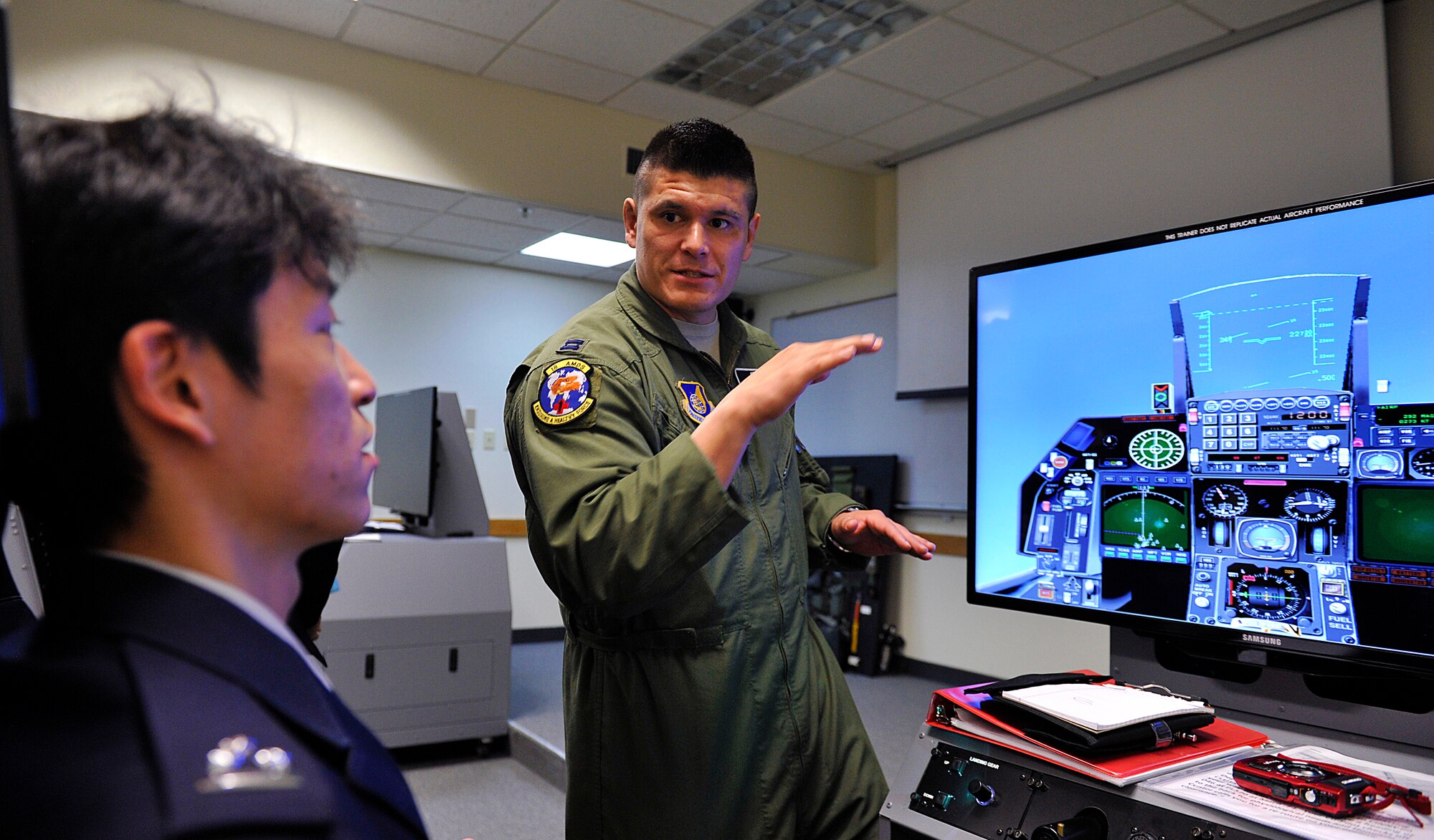 U.S. Air Force Capt. Ezekiel Duran, 18th Aerospace Medicine Squadron aerospace and operational physiologist, explains to Japan Air Self-Defense Force Capt. Makoto Inada, 4th Division, Aeromedical Laboratory flight surgeon, how to operate the Reduced Oxygen Breathing Device on Kadena Air Base, Japan, Feb. 12, 2015. Five JASDF personnel from the 4th Division, Aeromedical Laboratory, Iruma Air Base, Saitama, visited Kadena to learn how the U.S. Air Force conducts physiology refresher training without the need for an altitude chamber. (U.S. Air Force photo by Naoto Anazawa)