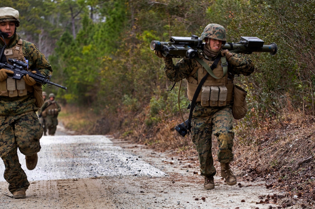 Marine Corps Pfc. Jonathan A. Velasco, right, carries an FIM 92A ...