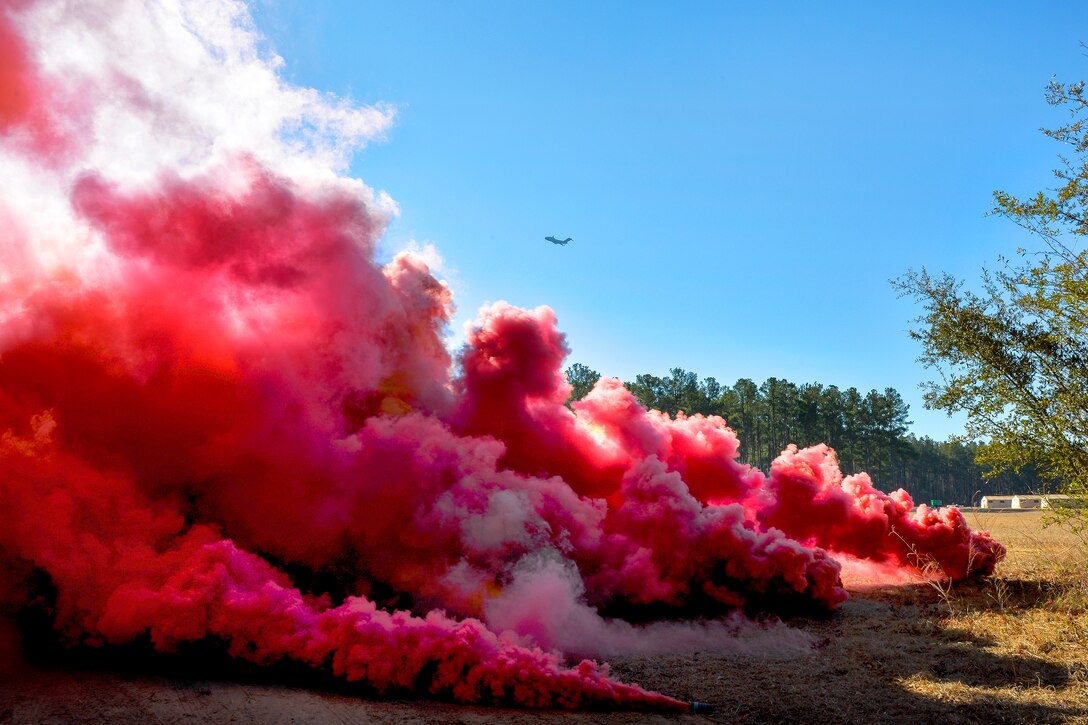 Red smoke is released to simulate a chemical attack blows in wind during exercise Scorpion Lens 15 on North Auxiliary Airfield in the city of North, S.C., Feb., 12, 2015. 