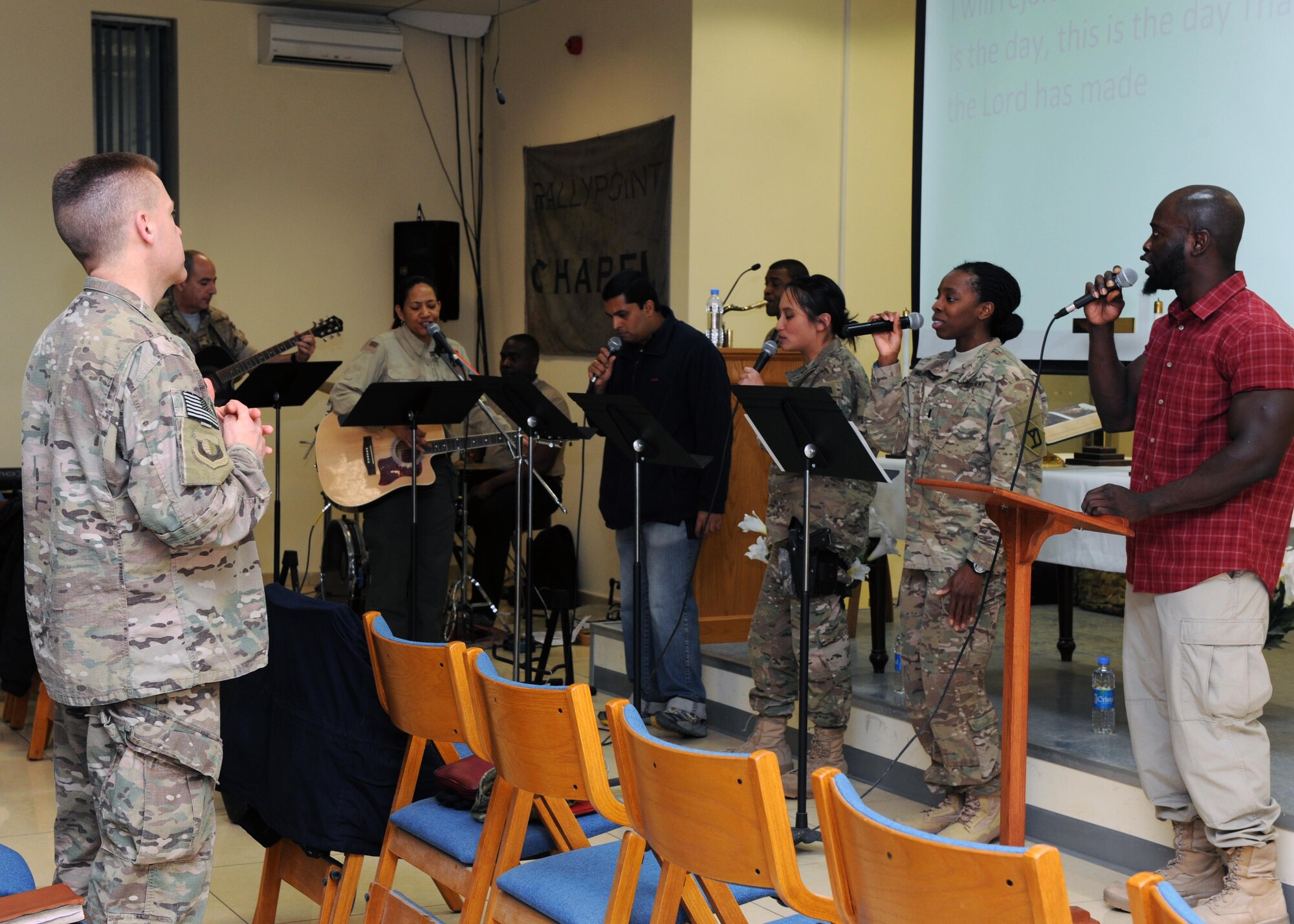 U.S. Air Force Maj. William Braswell, 455th Air Expeditionary Wing chaplain, listens to the praise and worship team prior to conducting an evening church service during a Religious Support Team visit Feb. 15, 2015 at Hamid Karzai International Airport in Kabul. Braswell, accompanied by U.S. Air Force Tech. Sgt. Aleric Hebert, 455 AEW chaplain assistant, travels throughout the U.S. Air Force Central Command Area of Responsibility engaging with Airmen and conducting church services to ensure deployed servicemembers are spiritually fit to fight.(U.S. Air Force photo by Staff Sgt. Whitney Amstutz/released)