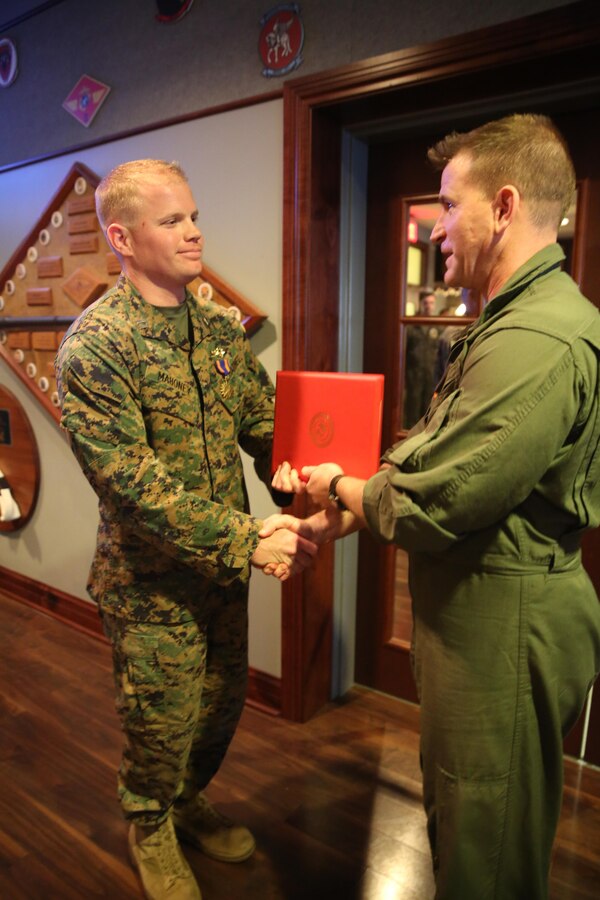Capt. William Mahoney, left, receives the Air Medal from Lt. Col. Roger T. Mcduffie during a ceremony at Marine Corps Air Station Cherry Point, N.C., Feb. 12, 2015,for actions during an aircraft malfunction while deployed with Marine Medium Tiltrotor Squadron 263 (Reinforced) as part of the 22nd Marine Expeditionary Unit in the U.S. 6th Fleet area of  responsibility in June 2014. Mahoney is an AV-8B Harrier pilot with Marine Attack Squadron 223 at Marine Corps Air Station Cherry Point, N.C. Mcduffie is the commanding officer for Marine Attack Squadron 223.
