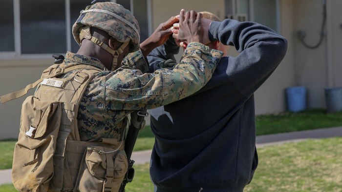 Marine captures role-playing protester during Special Marine Air Ground Task Force embassy reinforcement exercise, Marine Corps Logistics Base Barstow, Calif.,Feb.10. Marines participating in the exercise came from Marine Corps Air Ground Combat Center Twentynine Palms and Marine Corps Base Camp Pendleton, both in Southern California.