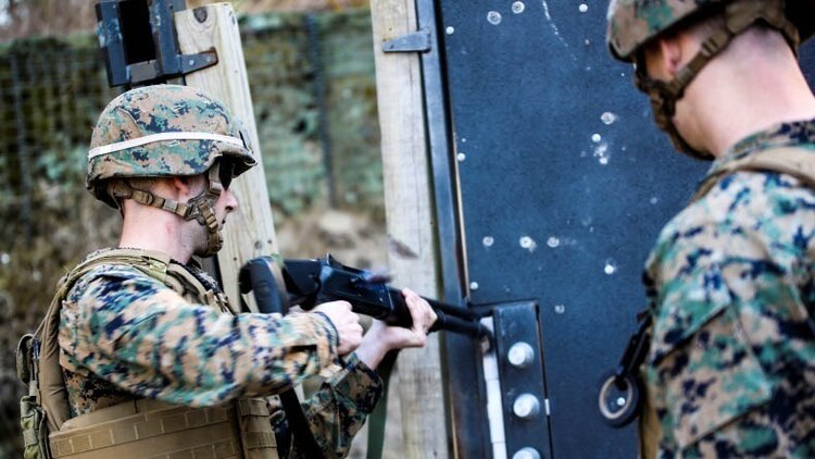 Sgt. Jordan Jeffries (Left) a combat engineer with 8th Engineer Support Battalion, 2nd Marine Logistics Group, 2nd Marine Expeditionary Force, prepares to breach a door at Engineer Training Area 1 aboard Marine Corps Base Camp Lejeune, N.C., Feb. 12, 2015. Breacher rounds are used specifically for the purpose of breaking the bolt quickly so Marines can enter promptly.