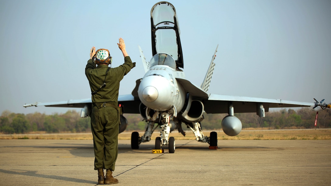 A U.S. Marine helps conducts a function check on an F/A-18 Hornet before takeoff, Feb. 16. U.S. Marines attached to Marine Aircraft Group 12, 1st Marine Aircraft Wing, III Marine Expeditionary Force, and the Royal Thai Air Force train together to maintain readiness and interoperability in support of peace and security in the region as part of Exercise Cobra Gold 2015. 