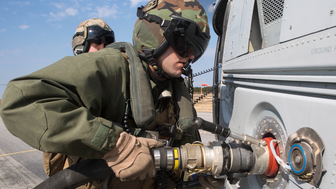 A crew chief inserts a hose into a Bell UH-1Y Venom to begin refueling the aircraft during Marine Wing Support Squadron 272’s forward arming and refueling point exercise at Engelhard, N.C., Feb. 12, 2015. The squadron’s FARP exercise is designed to get the Marines to refuel landed helicopters as quickly as possible, so the aircrafts can quickly take off after filling up. 