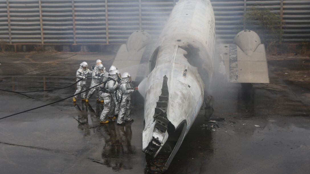 U.S. Marines and Royal Thai Navy firefighters douse a fire inside the shell of an old airplane during a fire response scenario for exercise Cobra Gold 2015 Feb. 18 at Utapao Royal Thai Navy Airfield, Kingdom of Thailand. Exercise Cobra Gold is an annual exercise designed to increase cooperation, interoperability and collaboration among partner nations in order to achieve effective solutions to common challenges. 