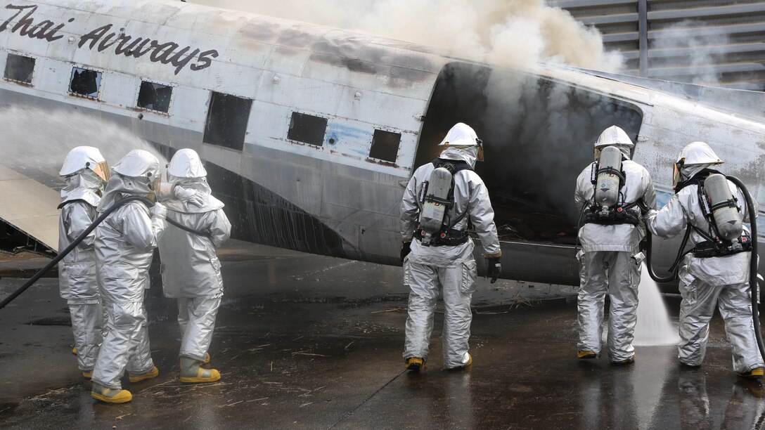 U.S. Marines and Royal Thai Navy firefighters practice extinguishing fires on an old airplane during exercise Cobra Gold 2015 Feb. 18, at Utapao Royal Thai Navy Airfield, Kingdom of Thailand. Exercise Cobra Gold is an annual exercise designed to improve international partnerships and security within the region. 