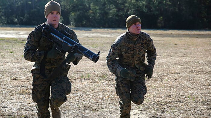 Lance Cpl. Casey Miller (left) and Lance Cpl. Alex Winnecke, assaultmen with Easy Company, 2nd Battalion, 2nd Marine Regiment and natives of Lexington, Ky. and Blaine, Minn., respectively, return to their starting position during a gun drill at training area G-G aboard Camp Lejeune, N.C., Feb. 18, 2015.  The assaultmen refined their skills with their primary weapon, the Shoulder-Launched Multipurpose Assault Weapon, over three days of training.