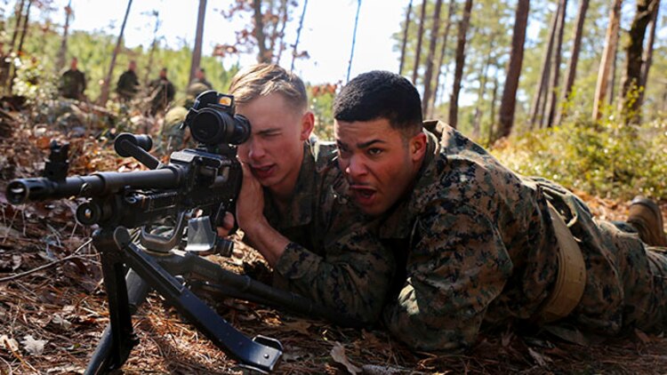 Lance Cpl. Zachary Painter (left) and Lance Cpl. Reymond Kane, machine gunners with 2nd Battalion, 2nd Marine Regiment and natives of Roanoke, Va. and Long Island, N.Y., respectively, simulate firing at an enemy during a gun drill at training area G-G aboard Camp Lejeune, N.C., Feb. 18, 2015.  During the drill, Marines ran to a specified point, set up their machine guns as quickly as possible, and began firing upon a mock enemy.